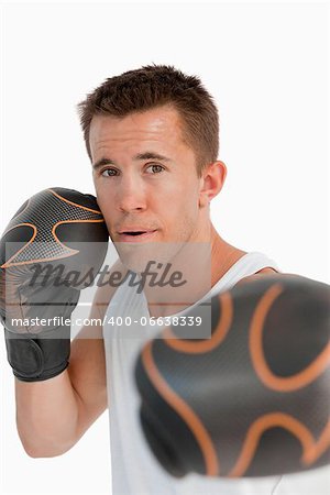 Close up of attacking boxer against a white background