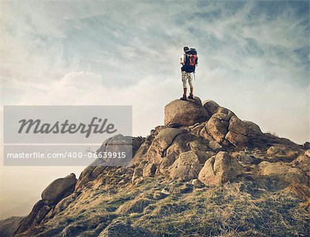 Young traveler standing on the top of a hill