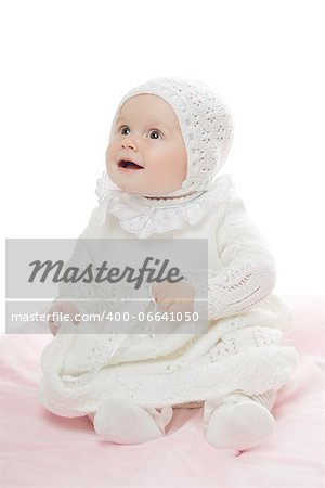 Prankish baby girl wearing white clothes. High key