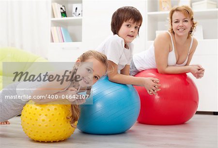 People exercising with large rubber balls - health education in children