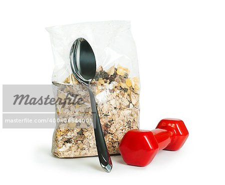 Muesli breakfast in transparent package.Spoon and dumbbell white isolated