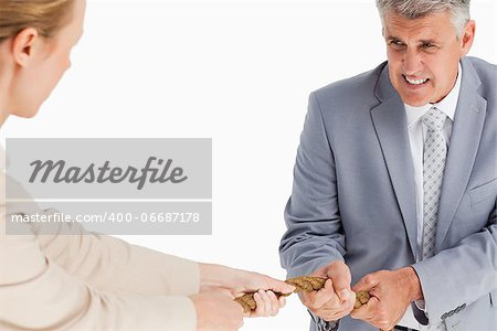 Businessman pulling a rope against white background