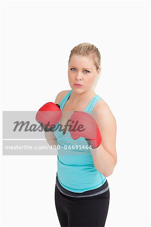 Woman wearing sportswear and gloves against white background