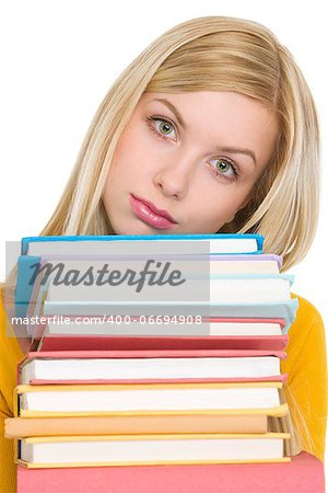 Frustrated student girl holding stack of books