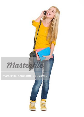 Full length portrait of smiling student girl talking mobile phone