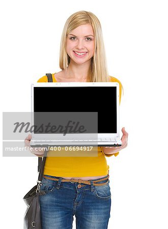 Smiling student girl showing laptop