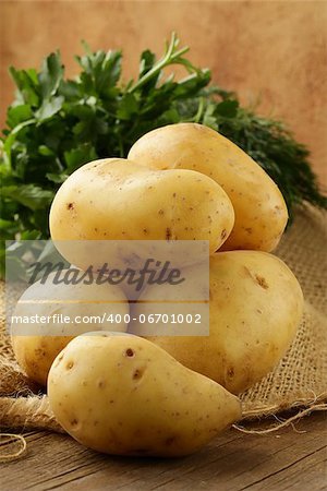 fresh organic potatoes on a wooden table