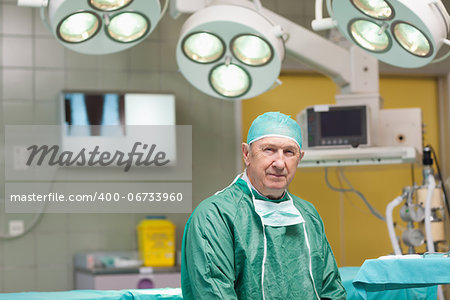 Sedate surgeon looking at camera in an operating theatre