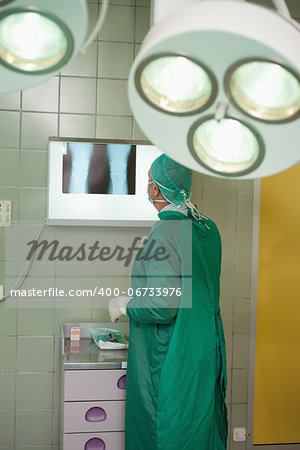 Surgeon looking at x-rays in a surgical room