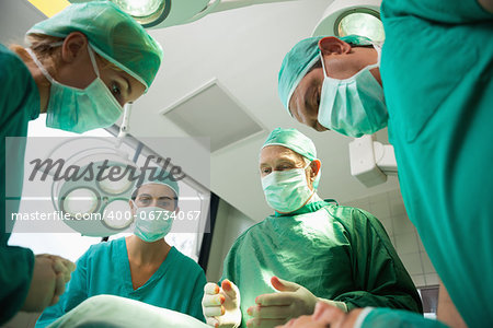 Surgical team working on a bleeding patient in a surgical room