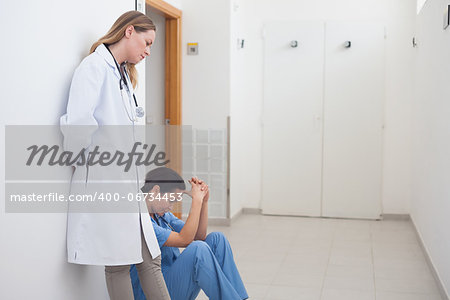 Doctor standing next to a nurse in hospital ward