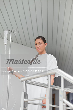 Sick patient looking at camera in hospital corridor