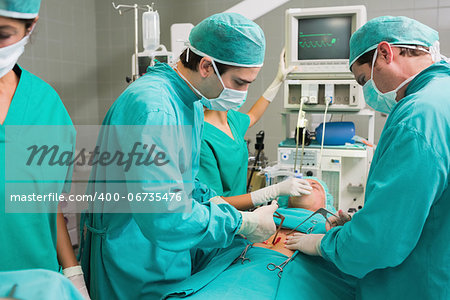 Surgeons operating with surgical tools in an operating theatre