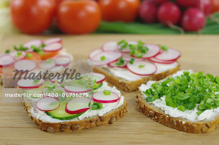 four slices of bread with cottage cheese and the vegetables