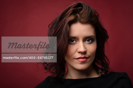 Young cute woman on a red background