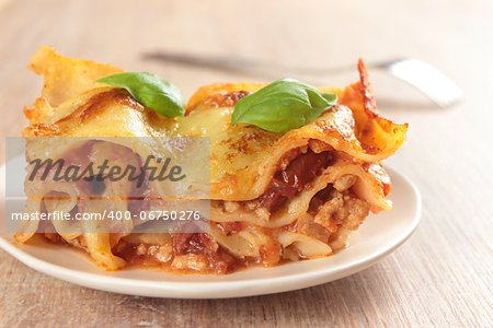 a portions of lasagne on white plate
