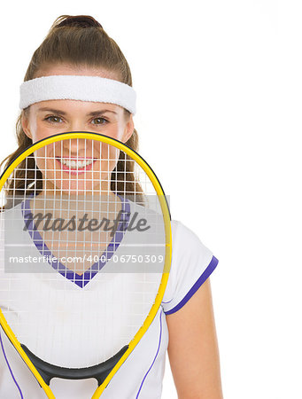 Happy female tennis player holding racket in front of face