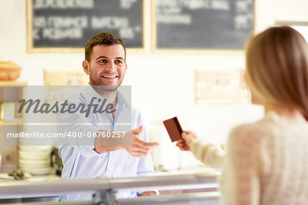 Wman with a credit card at the counter