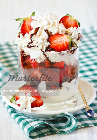 Whipped cream with strawberry and chocolate topping.
