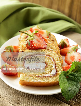 roulade cake with cream and fresh strawberries