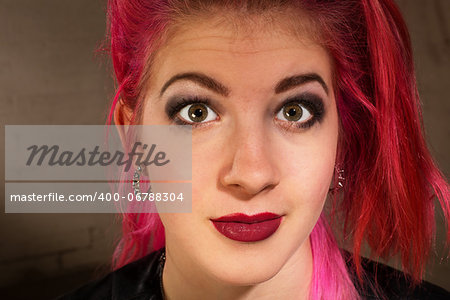 Young female with pink hair staring ahead