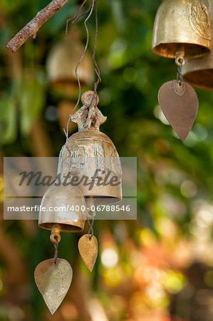 Tradition buddhist wishing bells on a tree in Thailand