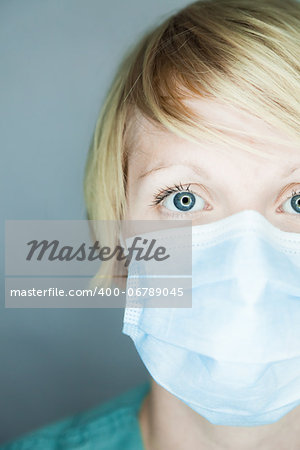 Young nurse in studio on a gray background