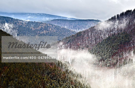 fog in winter Harz mountains, Germany, view from Ilsestein