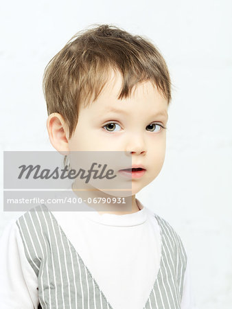 beautiful serious boy portrait, on white background
