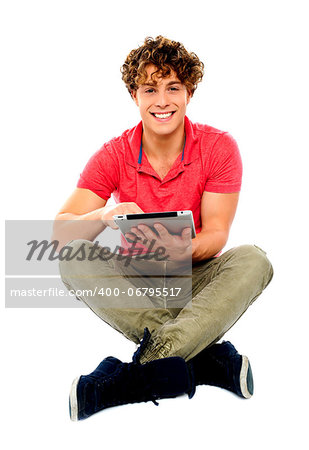Portrait of a boy using a tablet computer against a white background