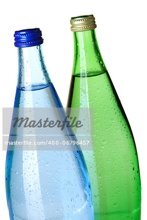 Two bottles of soda water with water drops. Closeup, isolated on white background