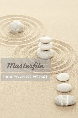 Balance of three zen stones in sand