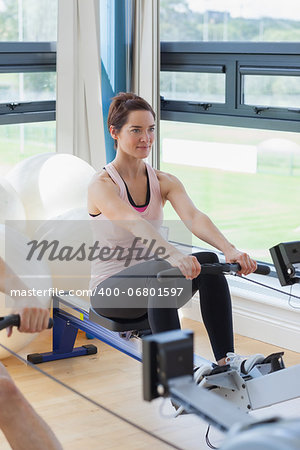 Woman rowing at the gym