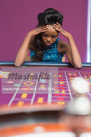 Woman losing at roulette in casino