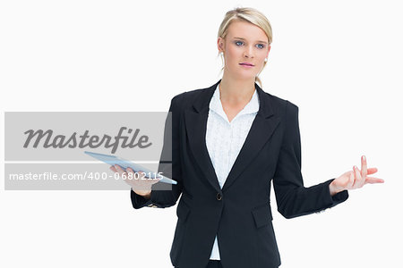 Businesswoman wondering while holding tablet and planning