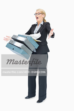 Businesswoman dropping many folders on white background