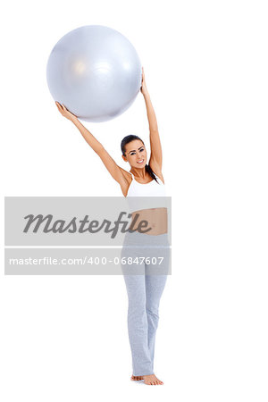 Woman doing exercises with fitness ball  she holding ball above her head