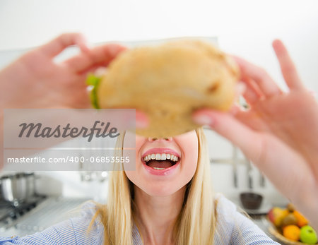 Closeup on teenager girl eating sandwich