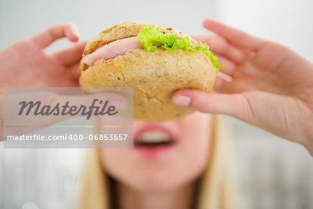 Closeup on teenager girl eating burger