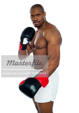 Strong african male boxer wearing black boxing gloves looking at you