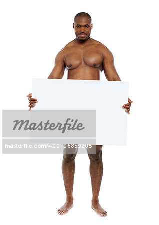 Naked black man hiding behind blank white billboard. Copyspace
