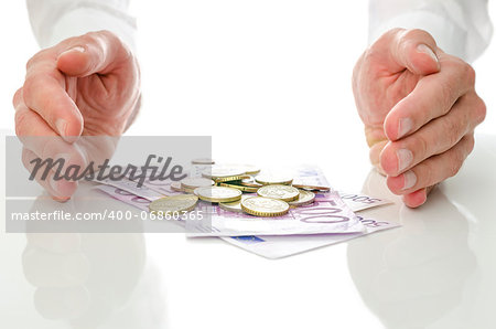 Male hands around Euro banknotes and coins. Concept of help and solution to economic crisis.
