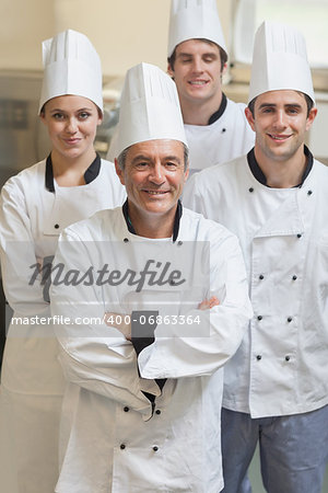 Group of Chef's smiling and standing in kitchen