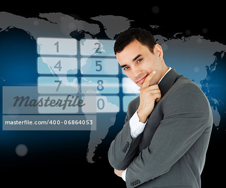 Businessman standing in front of number pad hologram on world map