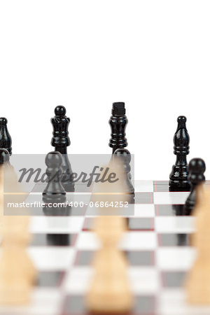 White and black chess pieces facing each other on the board