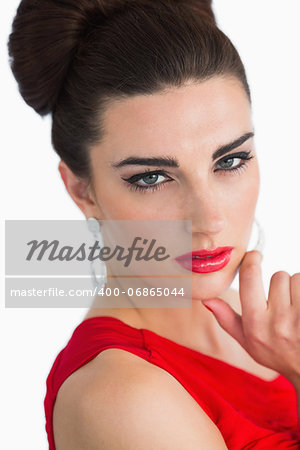 Woman with red lips and red red dress looking at camera