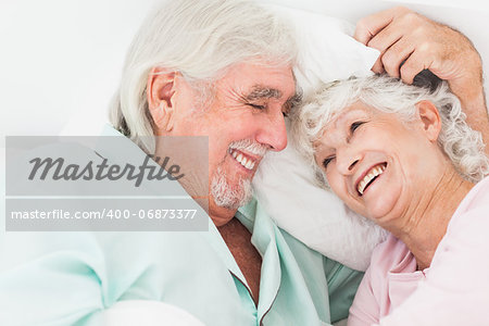 Happy older couple in bed