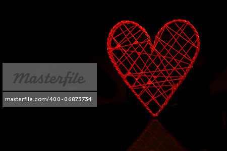 Red heart shaped ornamental box on black background