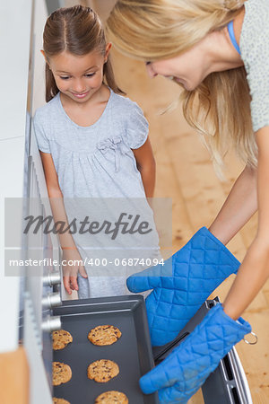 Mother and her daughter baking cookies in the kitchen