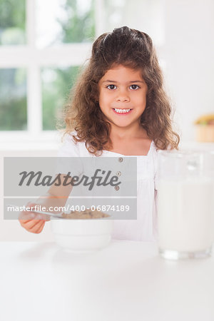 Little girl having cereal for breakfast